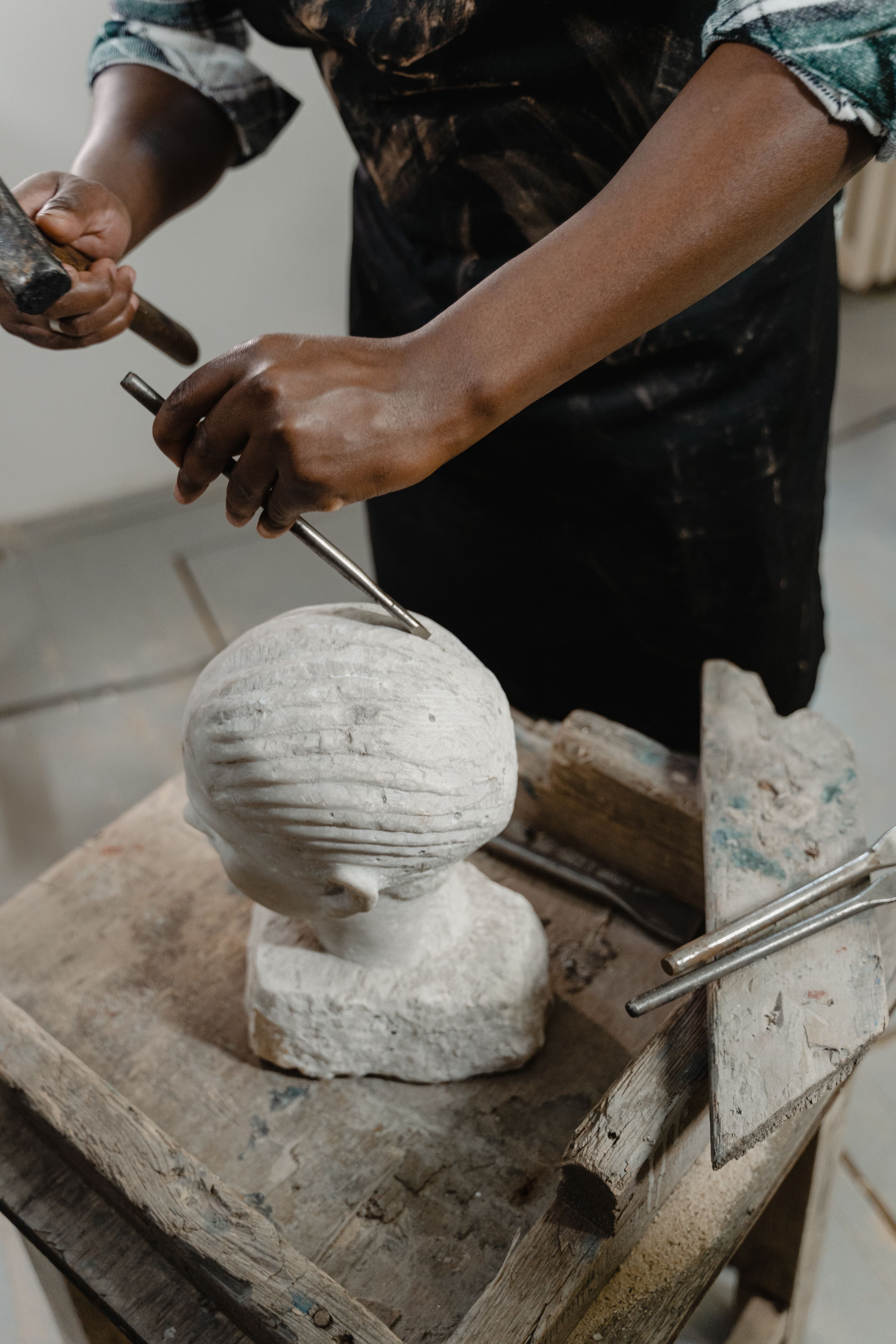 Sculptor carving a marble bust