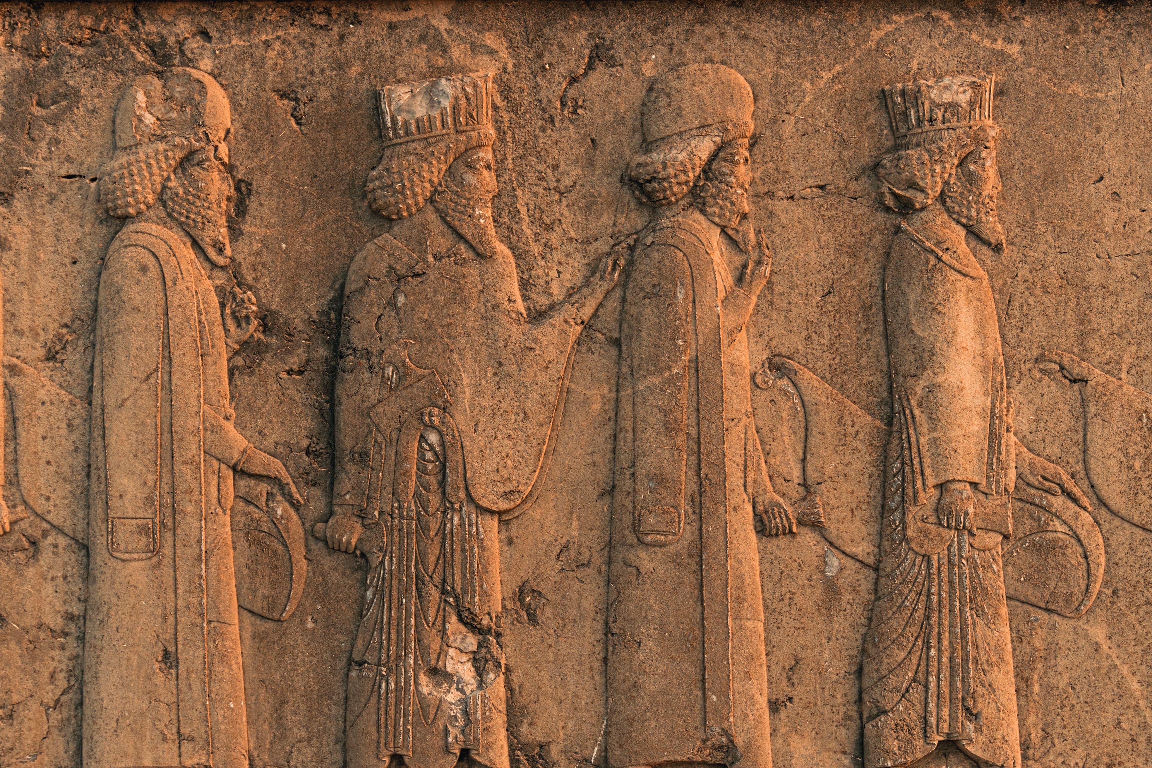 Ancient Mesopotamian stone relief depicting figures — evoking the Sumerian origins of the SUMERSON name